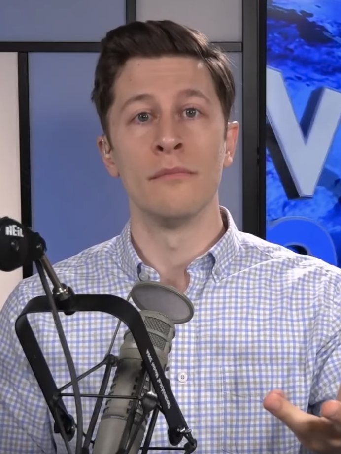 David Pakman in his studio behind a microphone, the political host behind David Pakman net worth