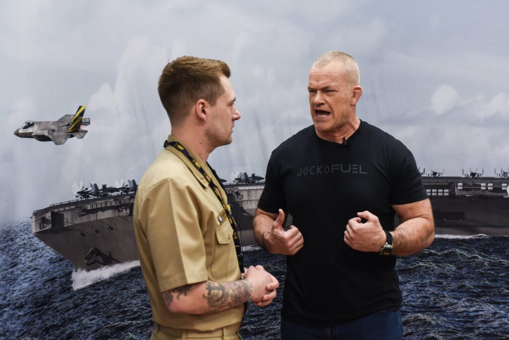 Jocko Willink talking with a Navy sailor at the Arnold Sports Festival, the retired SEAL behind Jocko Willink net worth