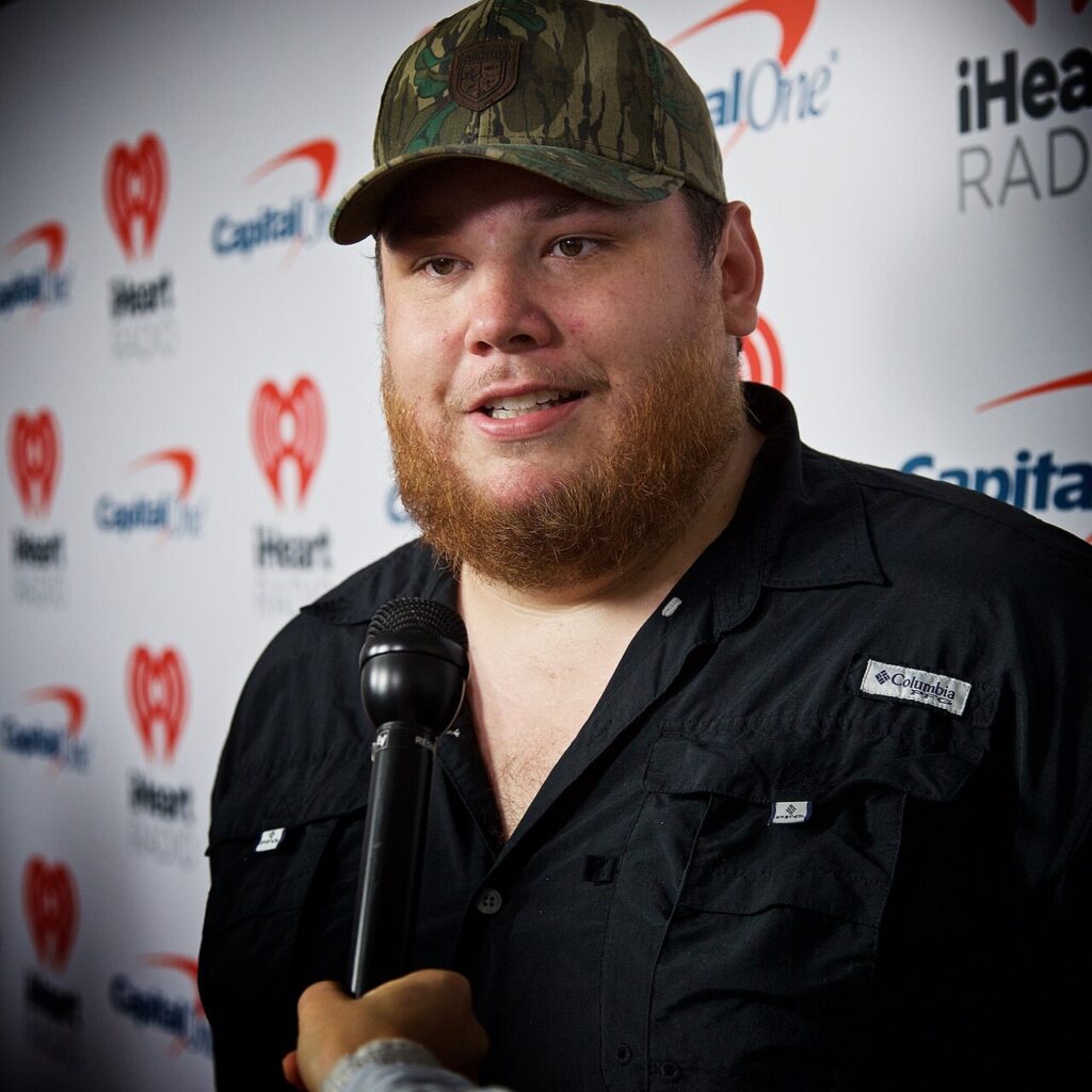 Luke Combs giving an interview at the iHeart Country Festival in Austin in 2019, as his rise lifted Luke Combs net worth