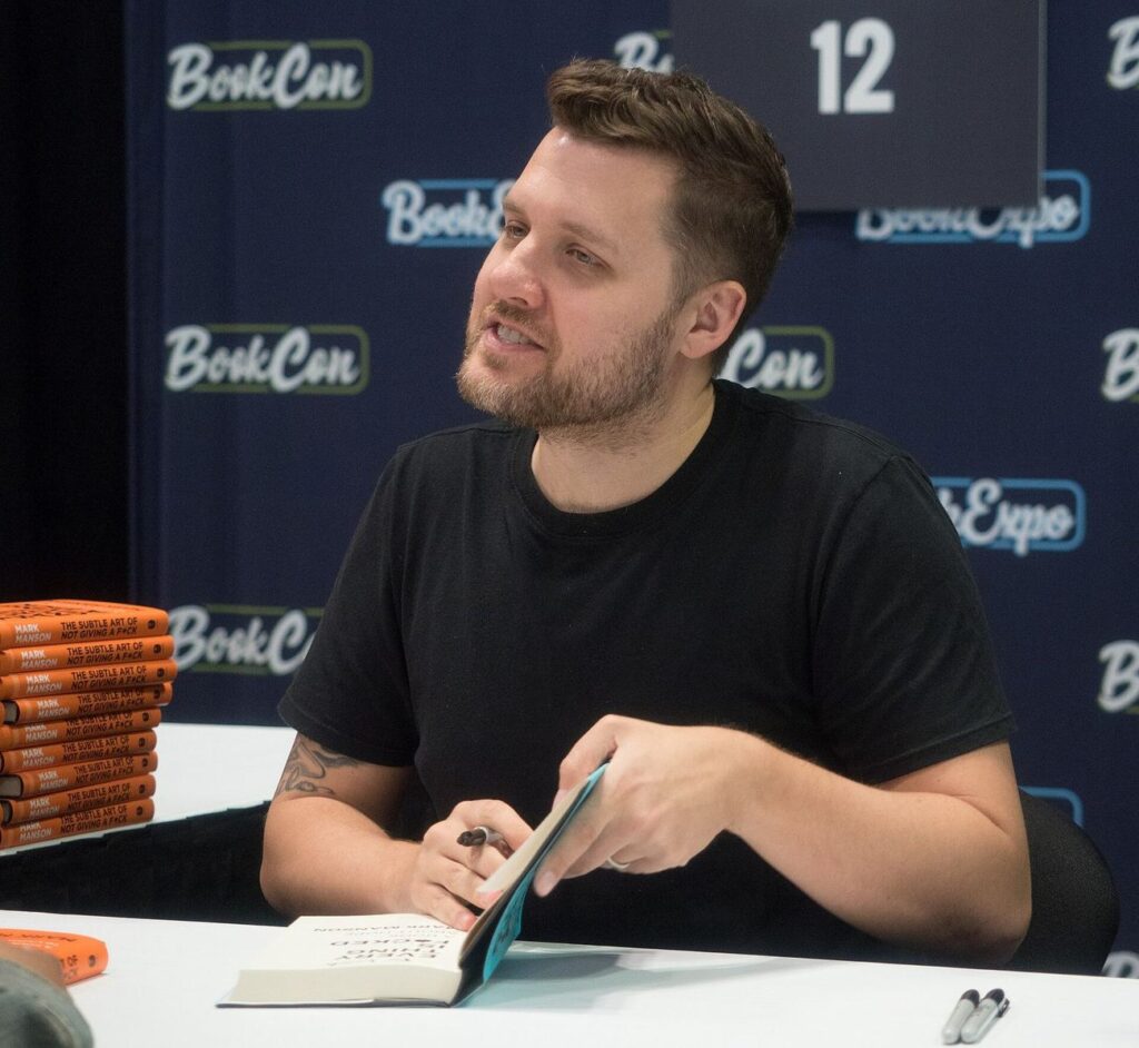 Mark Manson signing books at BookCon, as book royalties drive Mark Manson net worth